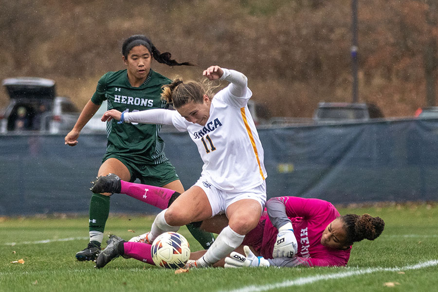 Graduate student midfielder slips to the ground against the William Smith College Herons. The game presented a defensive battle with the match being sent to double overtime and then a penalty shootout. The Bombers won 3-2 in the penalty shootout to claim the Liberty League title.