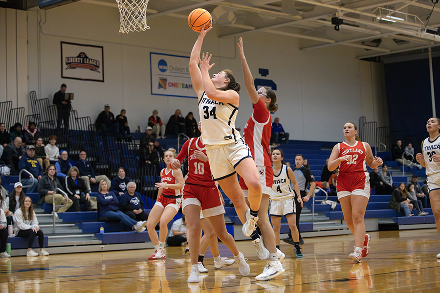 The Ithaca College women's basketball team fell to the SUNY Cortland Red Dragons in its season opener. Pictured, senior forward Annabella Yorio jumps up for a layup.