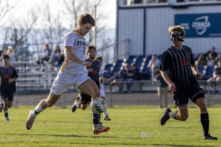 Sophomore walk-on forward Jack Carney moves the ball into the offensive zone in a match against the Rochester Institute of Technology Tigers on Oct. 30. Carney was tied for the team lead in goals on the season.