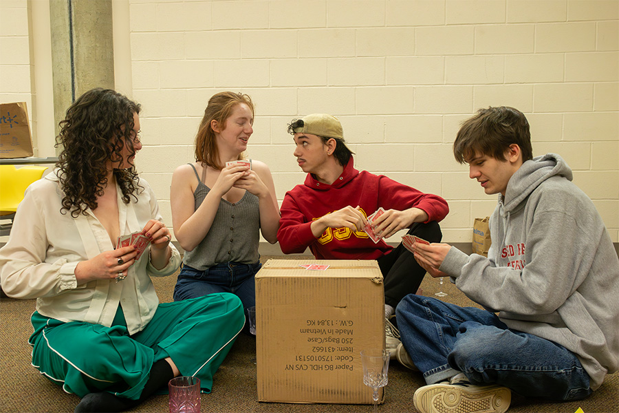 From left, Sylvia Grosvold, Anna Riley, Mikey Champion and Jack Abba rehearse a game of cards for the play.