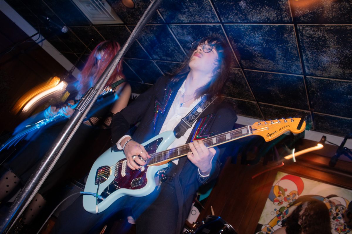 West Moore, lead vocalist and guitarist of anydayinjune, is deep in the music of the band's "Juniversary" show at The Sacred Root Kava Lounge & Tea Bar.