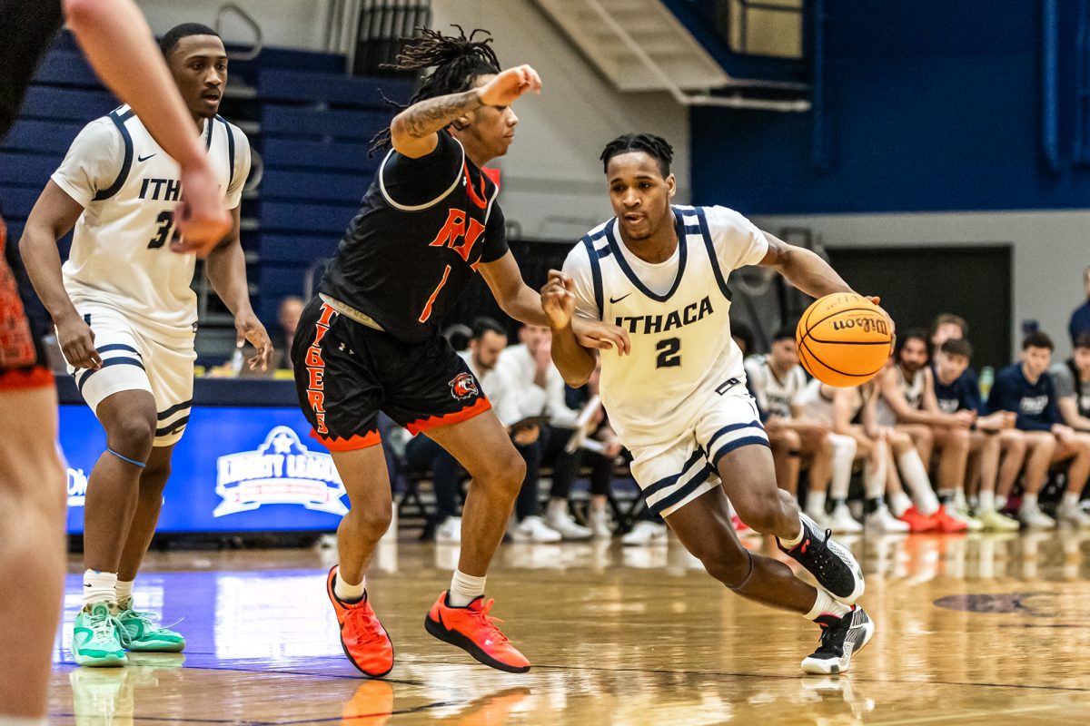 The Ithaca College men's basketball team came from behind to defeat the Rochester Institute of Technology Tigers Feb. 11. Pictured, sophomore guard Jaylon O'Neal drives past a Tigers' defender.