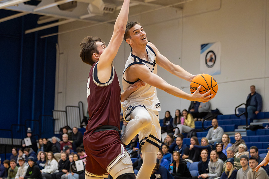 The Ithaca College men's basketball team defeated the Skidmore College thoroughbreds at Ben Light Gymnasium Feb. 7. Pictured, senior guard Logan Wendell goes for the layup against the Union College Garnet Chargers in a game from Feb. 1.