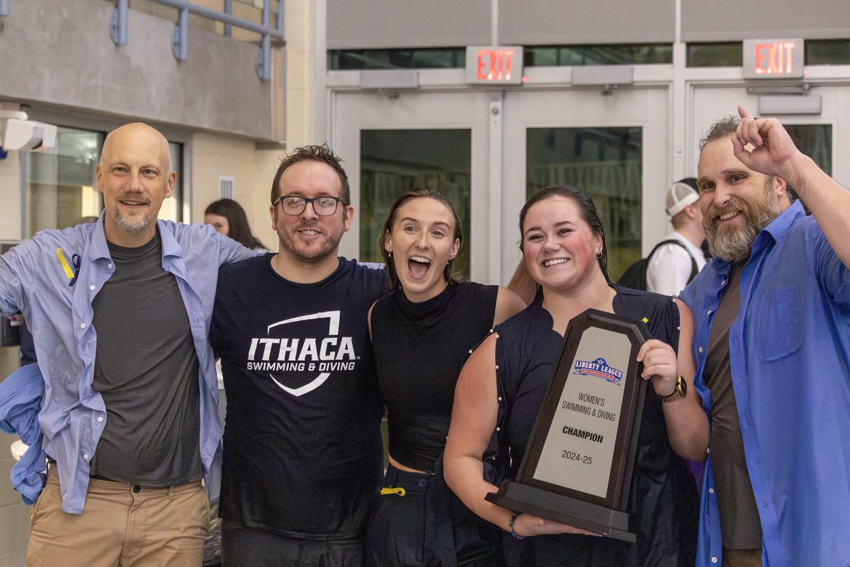 The Ithaca College women's swimming and diving team clinched its sixth consecutive Liberty League championship Feb. 22 at the Kelsey Partridge Bird Natatorium. The coaches come together with the trophy to celebrate.