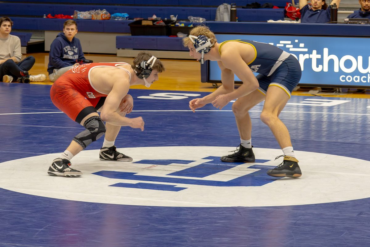 Brian Bienus squares off with his opponenet. His technical fall was one of nine bonus point victories for the Bombers.