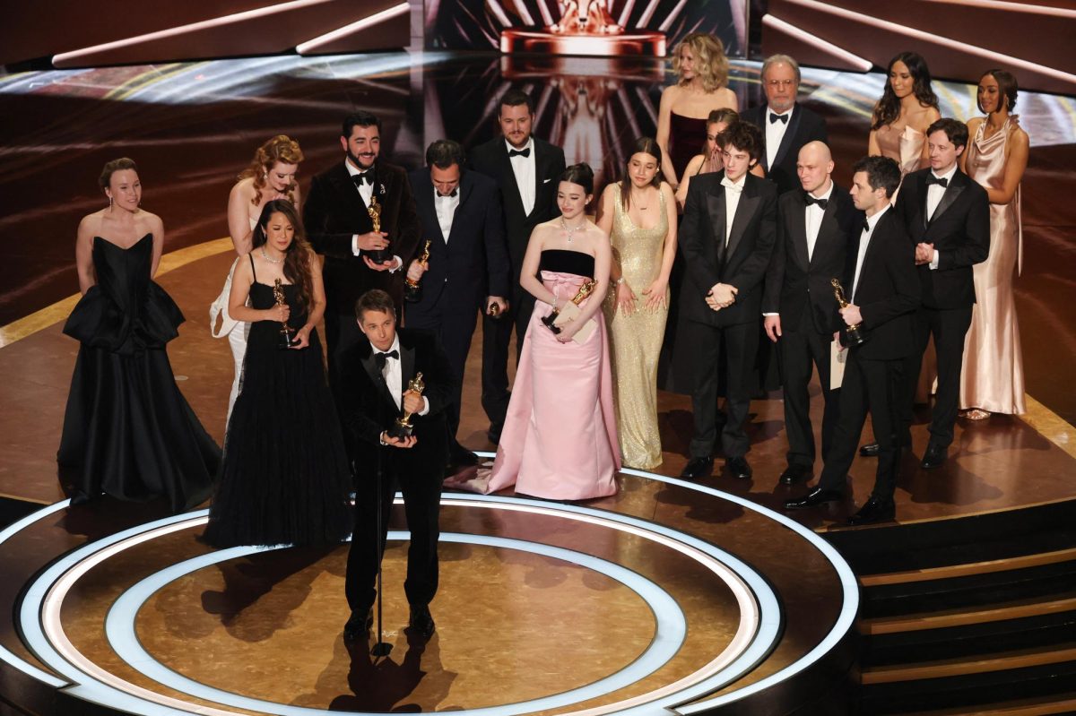 Director-writer Sean Baker (front) gives his acceptance speech with the rest of the "Anora" cast for the award for Best Picture. The film swept nearly every major academy category this year.