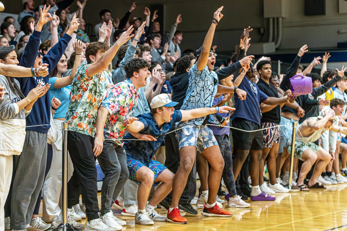 The students in the stands cheer on the Bombers as they take on the Tigers.