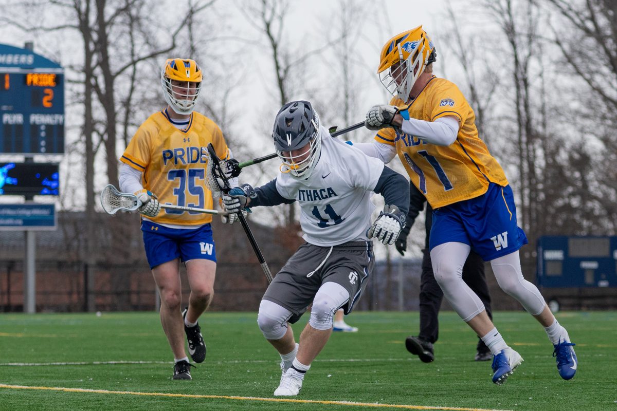 Senior midfield/faceoff Chase Gulick splits two Pride defenders in the attacking zone.