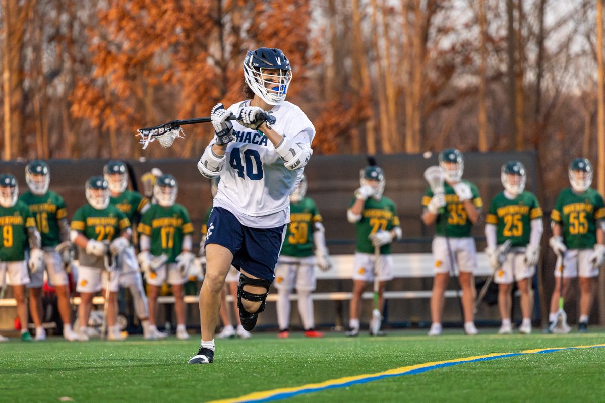 The Ithaca College men's lacrosse team defeated the SUNY Brockport Golden Eagles at Higgins Stadium March 19. Sophomore midfield Ethan Adrid prepares to pass the ball.