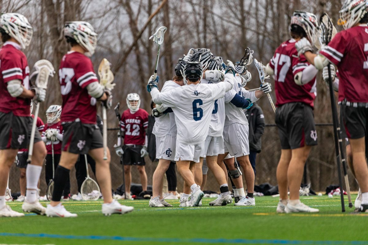 The Ithaca College men's lacrosse team opened its Liberty League schedule with a win over the Vassar College Brewers at Higgins Stadium. The team comes together after scoring a goal.