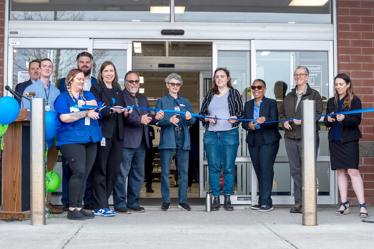 On April 26, community leaders and Goodwill officials gathered outside of the new retail location in Ithaca to mark its opening. Each participant cut a piece of the blue ribbon in front of a crowd.