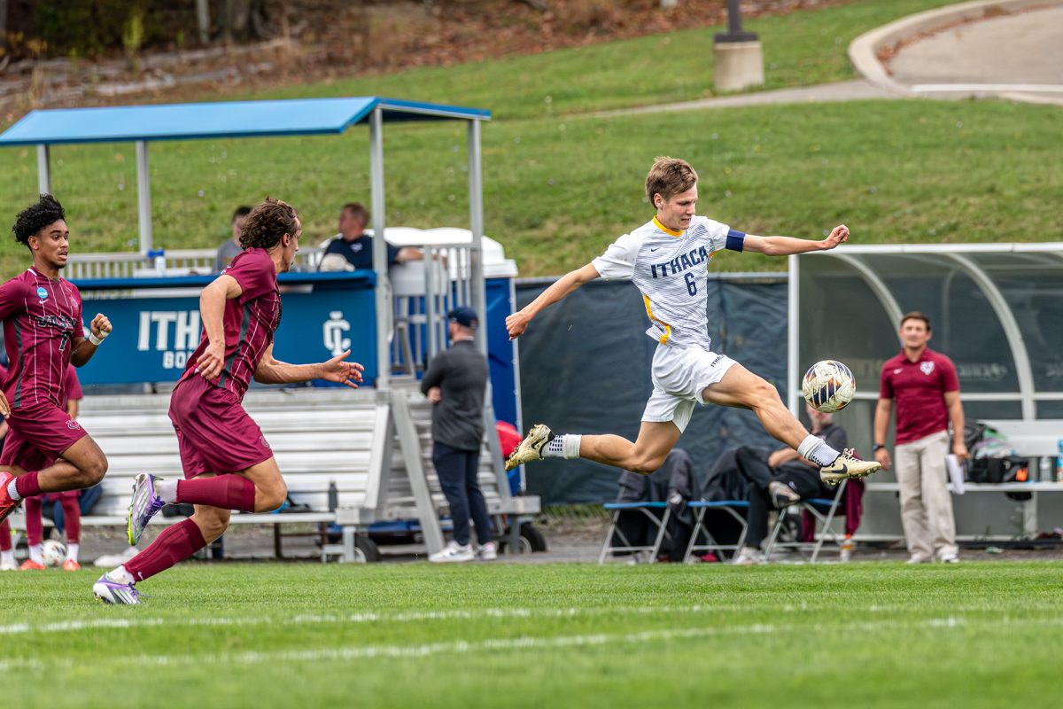 Junior midfielder Liam Breslin leaps ahead of the defending Vassar Brewers in a 1-1 draw on Sept. 27 at Carp Wood Field.