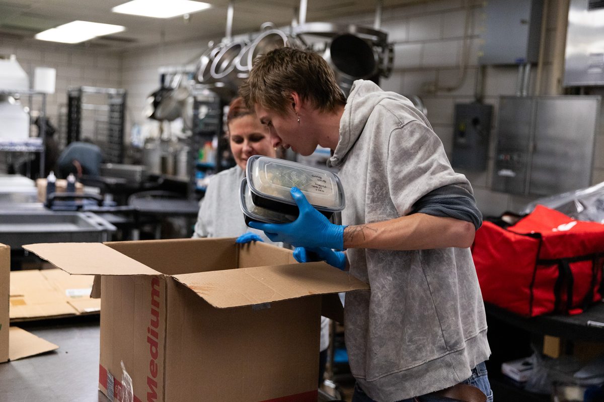 Junior Shay Mogge packages unused food on Sept. 19 in the Campus Center Dining Hall kitchen to distribute to people experiencing food insecurity in Ithaca.