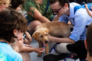 Junior Miguel Brand with Frost, the guiding eyes dog he is training with Ithaca College’s chapter of Guiding Eyes for the Blind.
