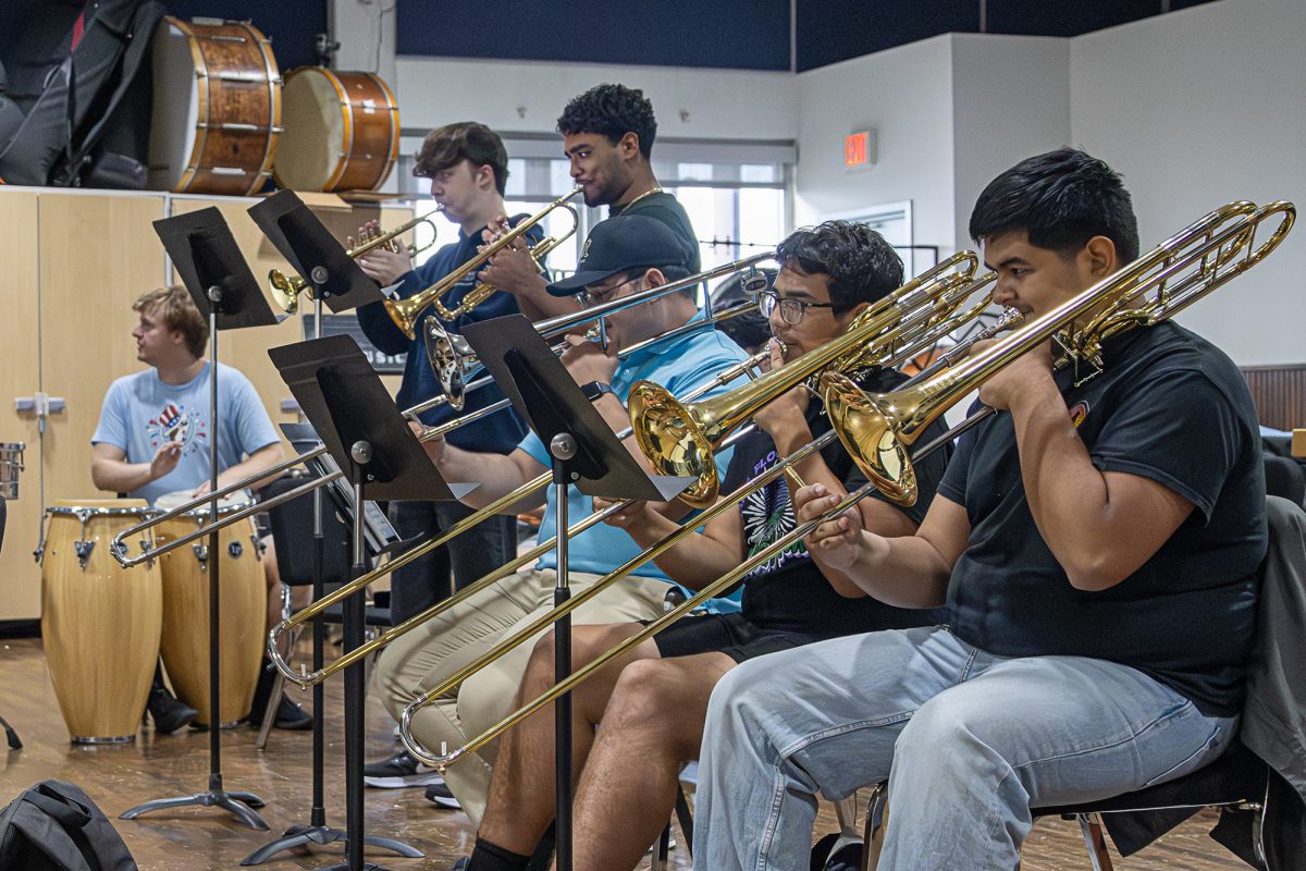Student musicians play trumpet, trombone and drums during their first run-through of salsa song “Tu con El” by Frankie Ruiz at Latin ensemble rehearsal on Sept. 6.