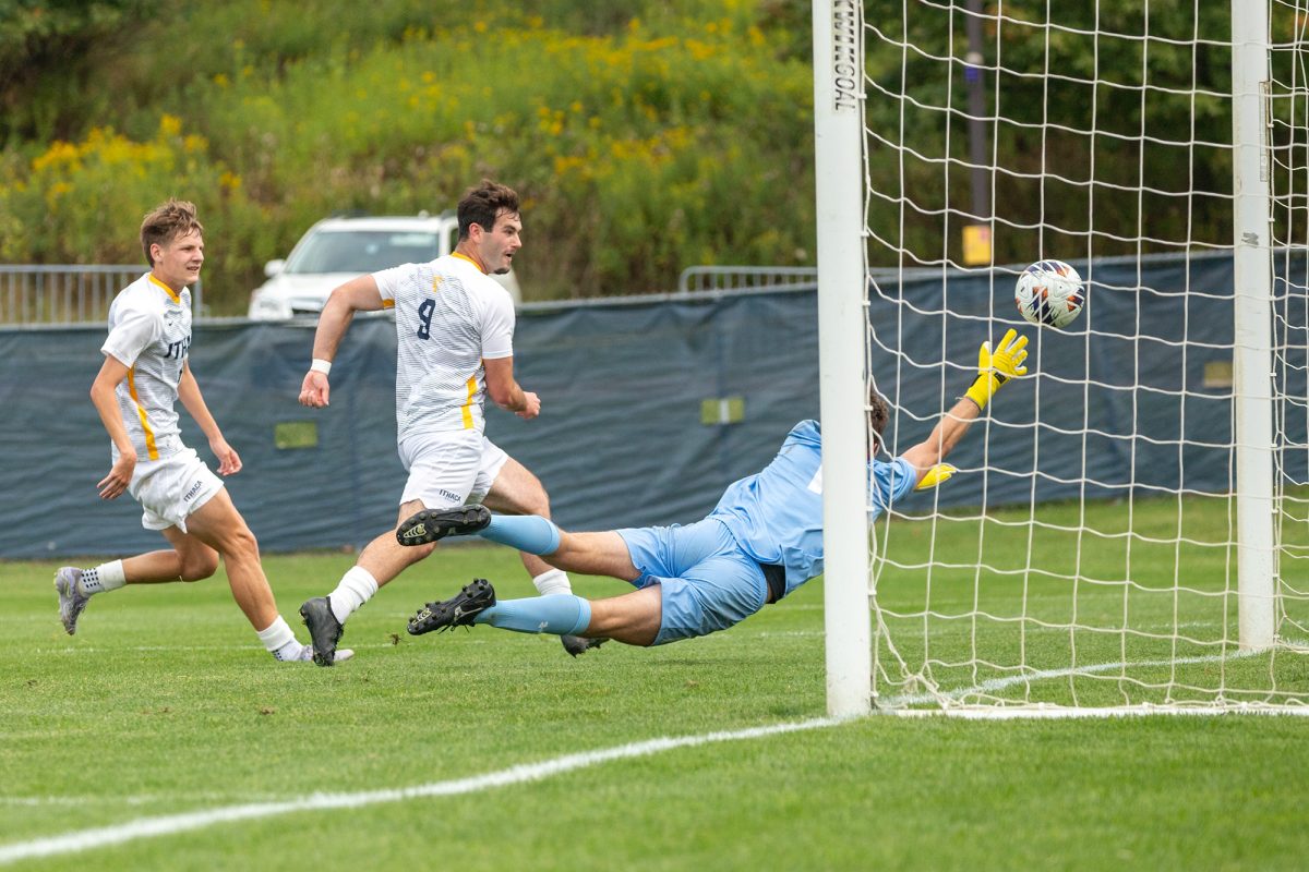 Senior forward Jared Krasnove and junior midfielder Liam Breslin crowd the goal in a 1-0 win over the SUNY Geneseo Knights on Sept. 6.