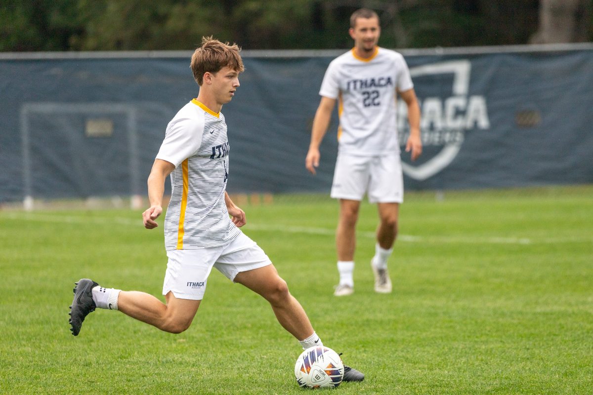 Senior midfielder Drew Warren kicks the ball out of the Bombers' zone.