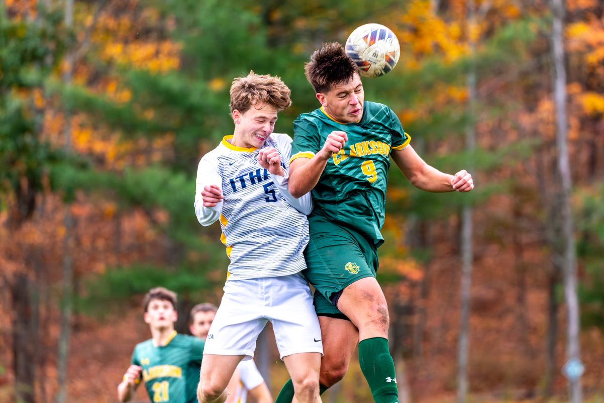 Clarkson sophomore forward Paul Rolland wins a header over senior midfielder Drew Warren