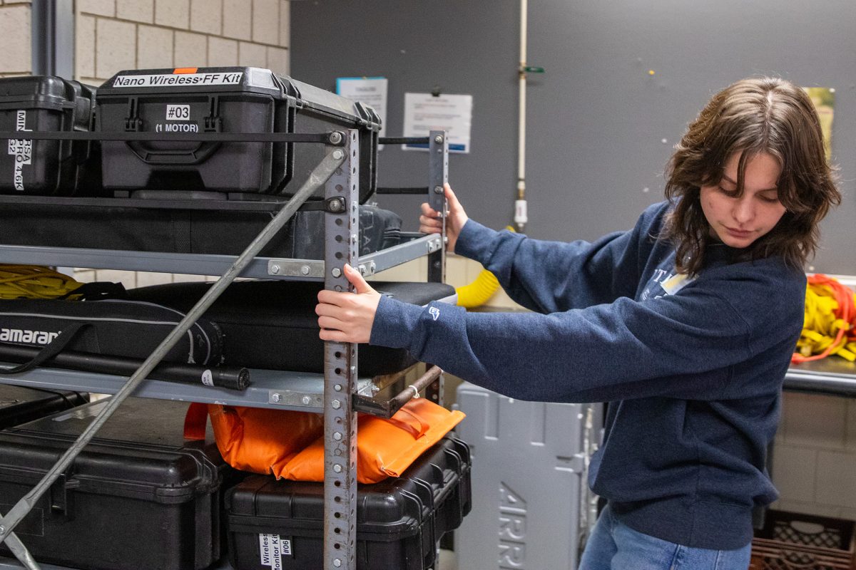 Senior Rhiannon Strazisar, one of the PPECS regular student managers, bringing in a returned equipment order in PPECS.