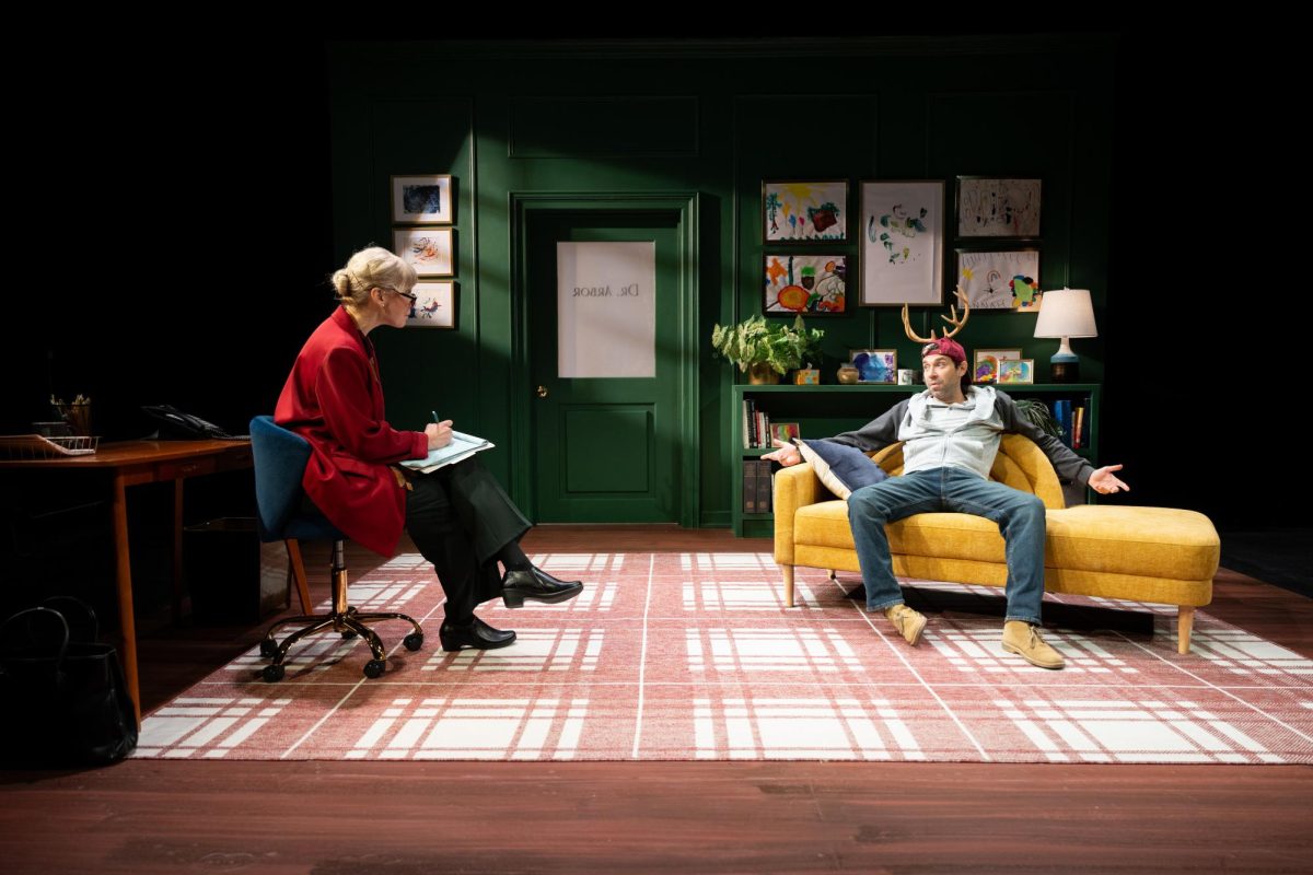 From left, Erica Steinhagen and Karl Gregory play Dr. Arbor and Blitzen in a hybrid holiday party and play that has Blitzen in therapy by request of Santa's human resources team. 