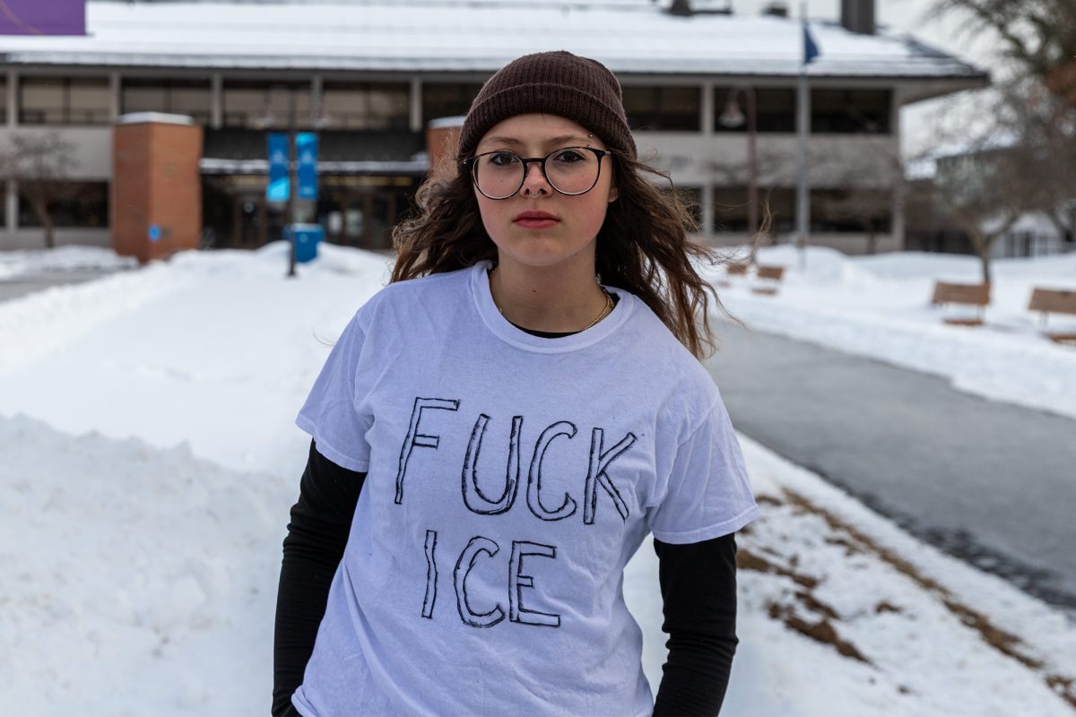 Sophomore Bella Phelps attends the walkout against ICE in the Academic Quad.