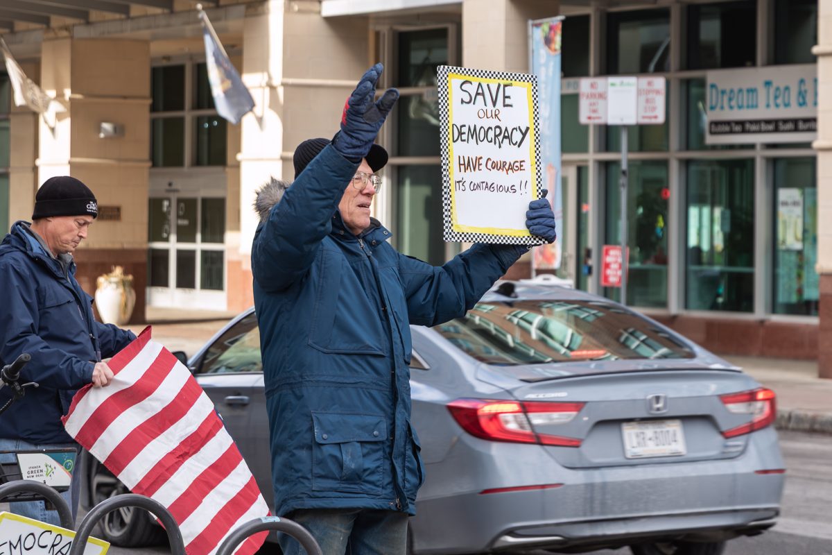 Ithaca community member Brian Caldwell attends Indivisible Tompkins’ Weekly Honk and Wave to Protect Democracy on Jan. 17 to protest the actions of United States President Donald Trump.