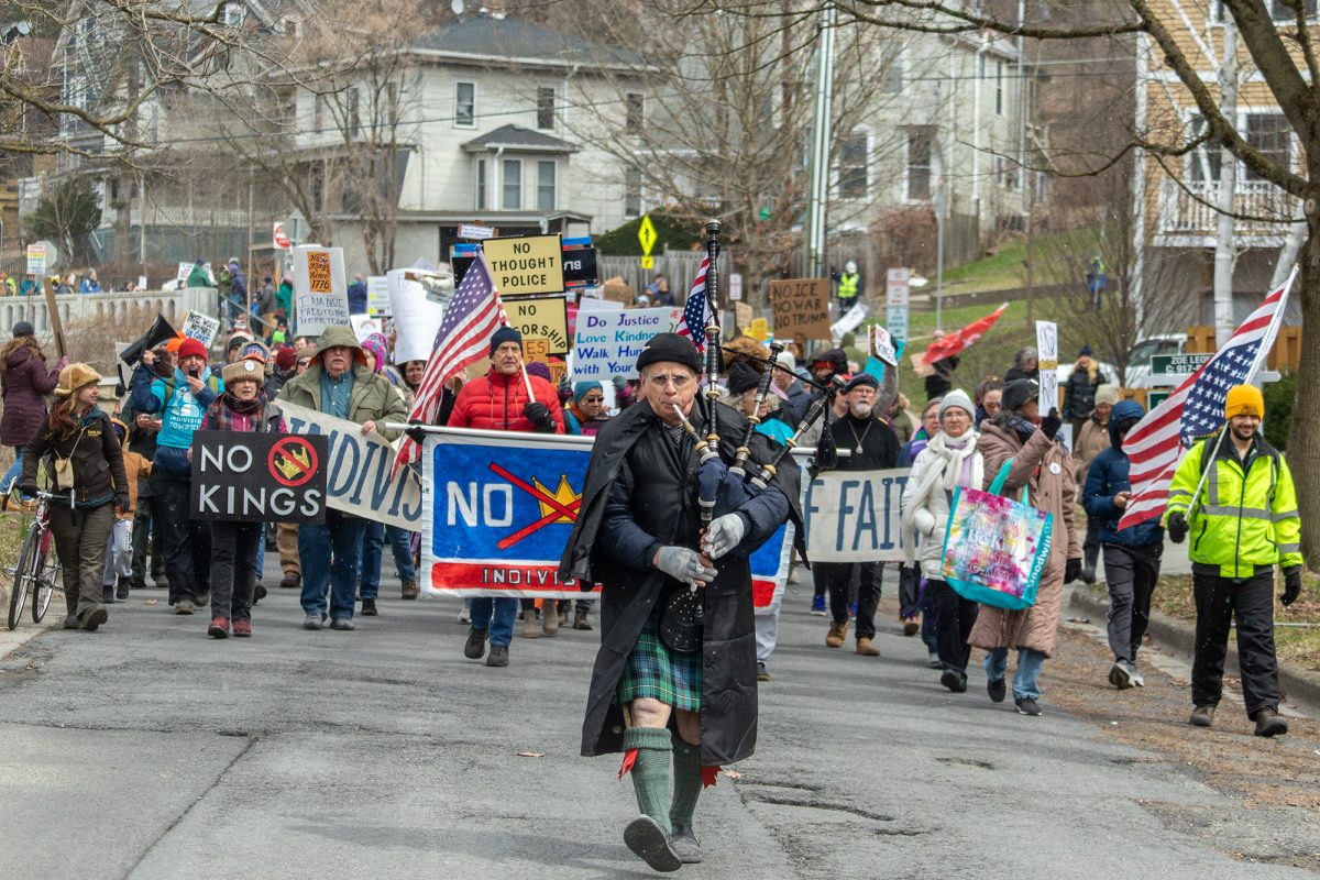 A protester playing bagpipes leads the march from The Commons to Meadow Street during the March 28 "No Kings" rally.