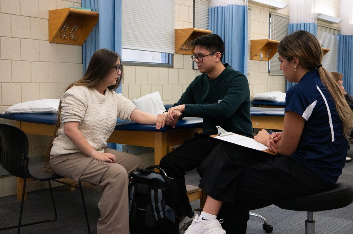 From left, senior Rachel Summers, a Vocal Music Education Major, with seniors Patrick Gayanelo and Megan Medina, who are both physical therapy majors, at the Performing Arts Walk-In Clinic. 