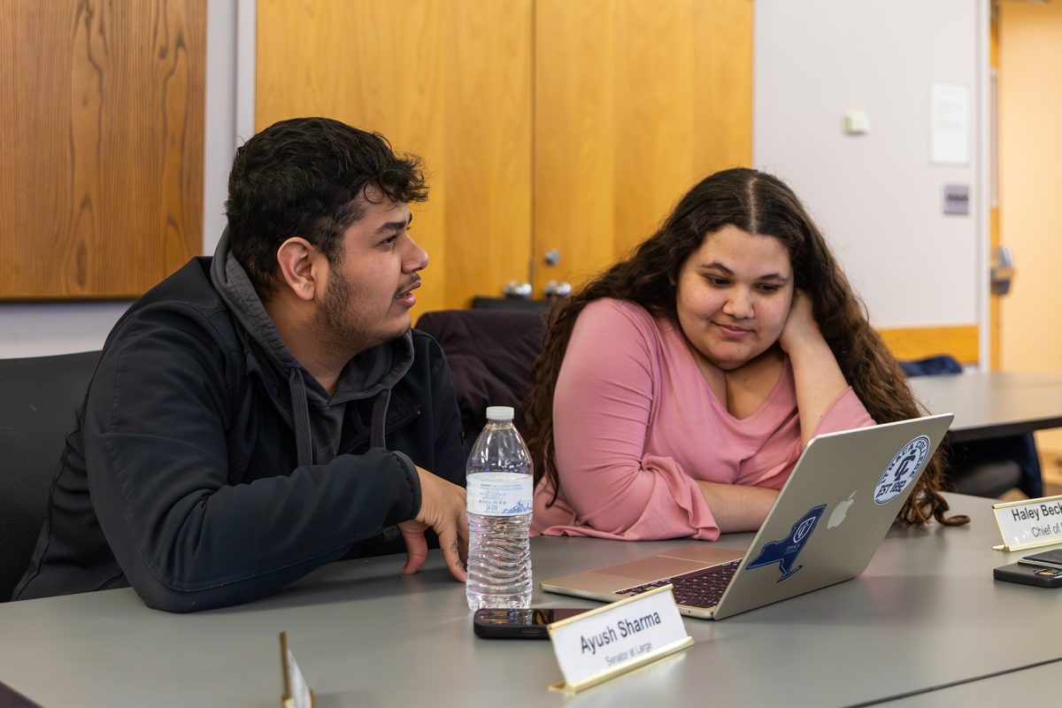 First-year student Ayush Sharma, senator-at-large, and senior Asata Rothblatt, vice president of academic affairs, discuss upcoming changes at the March 2 meeting.
