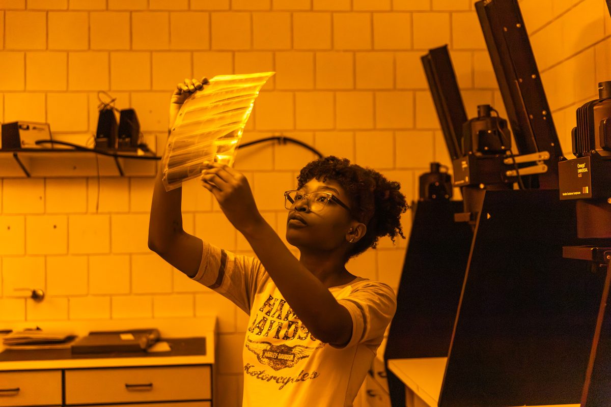 Junior Shelby Riley-Cherubin displays development steps in IC's darkroom. 