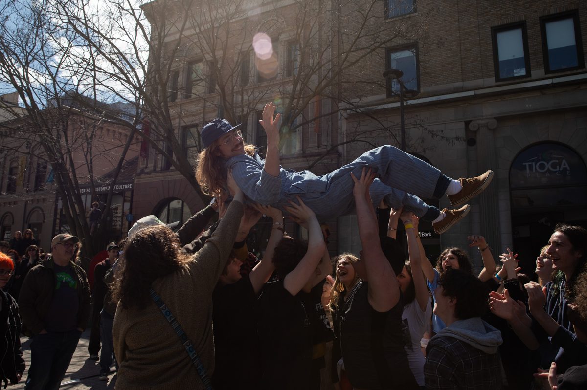 Senior Dominick Petrucci, one of the key organizers of DIY Fest, is lifted by a crowd of music fans at Bernie Milton Pavilion on The Commons. Before jumping into the audience, Petrucci proclaimed that he wanted to be the first person ever to crowd surf at the pavilion. 