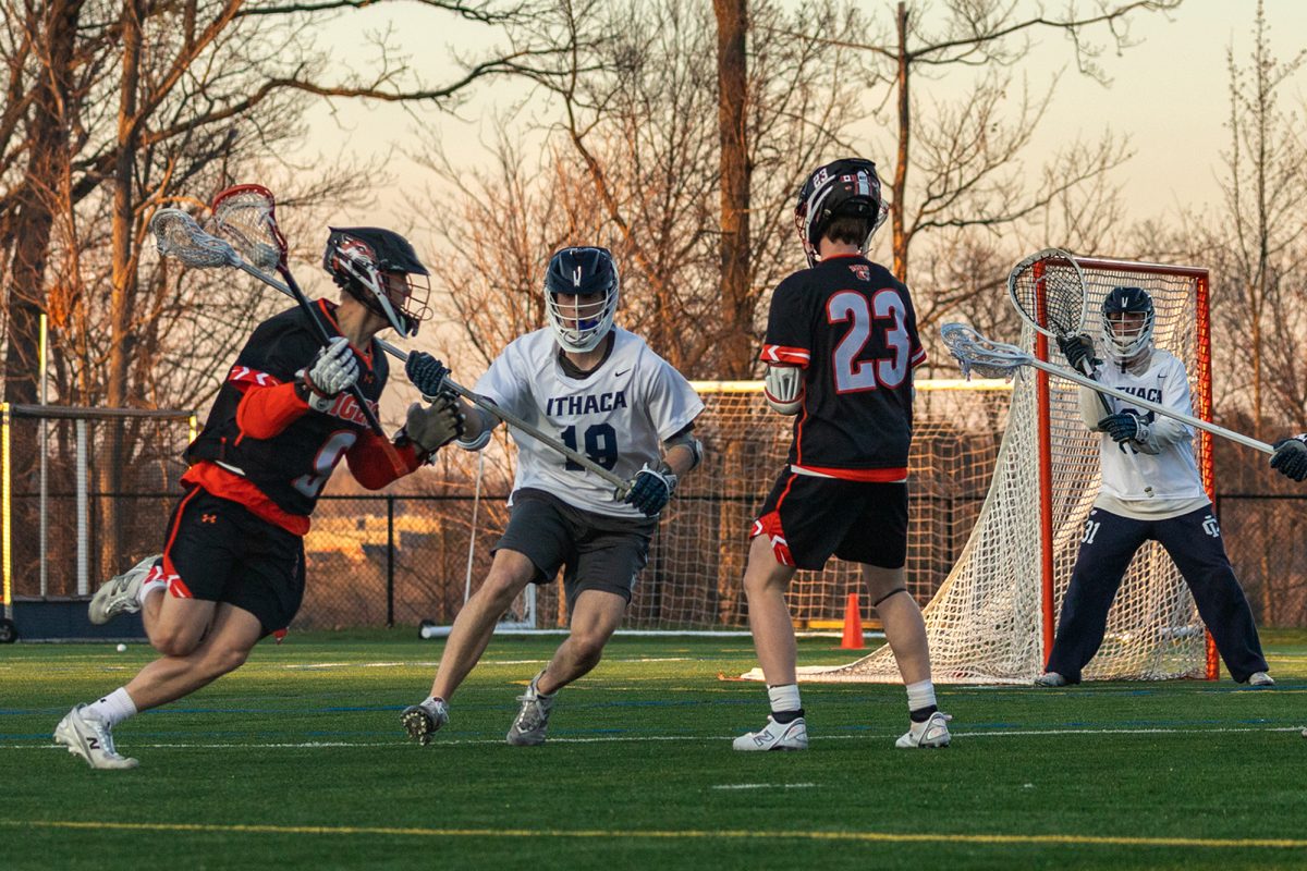 From left, first-year defender/long stick midfielder Harry O'Neal and senior goalkeeper Andrew Minard guard the ball in the possession of No. 6 Rochester Institute of Technology April 8 at Higgins Stadium. The Bombers held one of the conference's top offenses to just eight goals. 