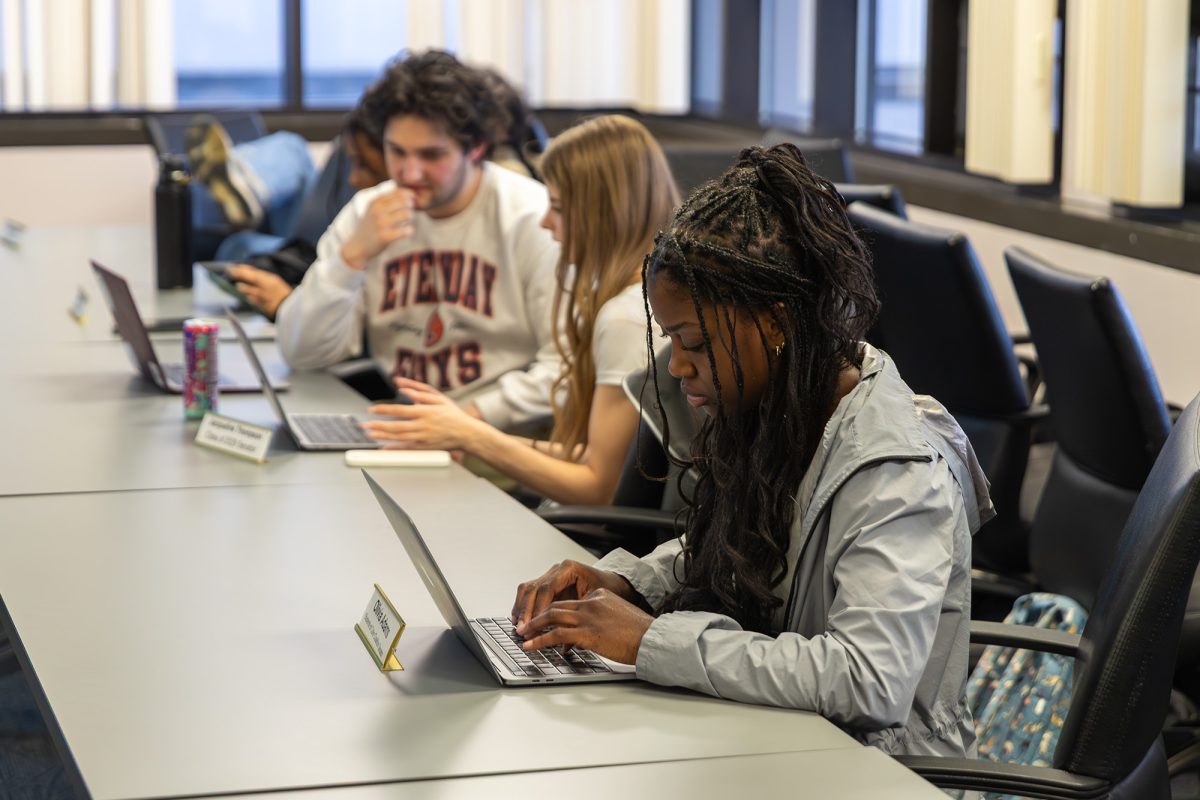 First-year student Olivia Adams, Students of Color Coalition Senator, works on her current initiative at the SGC meeting April 6. 